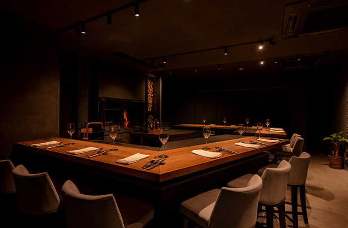 地下の扉を開ければ、薪の香り漂う、温かく洗練された隠れ家レストラン